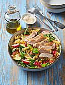 Pasta salad with chicken breast and sesame