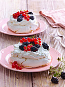 Pavlova cakes with blackberries and currants