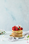 A stack of pancakes with fresh strawberries