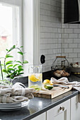 White fitted kitchen with black worksurface