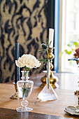 Glass vases and candlesticks on dining table
