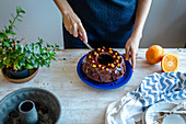 Schokoladen-Kranzkuchen mit Schoko-Orangenglasur wird angeschnitten