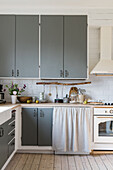 Kitchen with grey cupboard fronts in country-house style