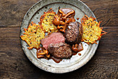 Venison steaks with wild mushrooms and mini potato fritters