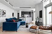 Blue velvet sofa in a modern, open-plan living room with designer style