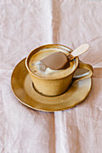 Cup of delicious aromatic coffee served with ice cream on stick