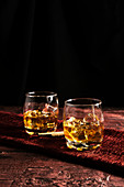 Close-up of two glass of whiskey on a table