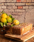 Lemon and poppy seeds cake garnished with sugar glaze and lemon zest