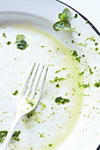 An empty plate with herbs and oil