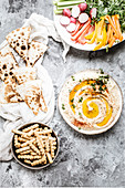 Hummus served with vegetables and flatbread