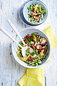 Green asparagus salad with peas, oranges, bacon and feta