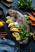 Fresh trout with lemon and onions for preparation in kitchen