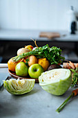 Bunch of various fresh fruits and vegetables placed on counter during lunch preparation