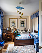 Antique wooden bed and desk in teenager's bedroom with blue accents