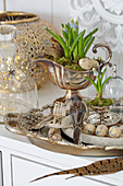 Easter decoration with a bird figure, eggs, and grape hyacinth