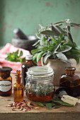 Tinctures of sage and rose petals in glass jars