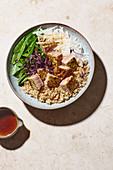 A poke bowl with tuna, quinoa and mange tout