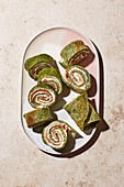 Spinach pancake rolls filled with smoked salmon