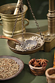 Weighing pan of an antique apothecary's scale with herbs