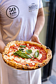 Pizza Margherita being served