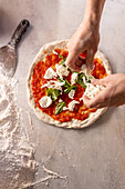 Pizza Margherita zubereiten, mit Mozzarella belegen