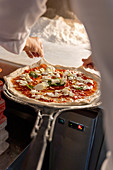 Pizza Margherita being made