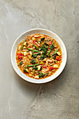 Vegan minestrone with a lemon topping