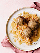 Liver dumplings with sauerkraut and onion sauce