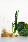 Food in plastic bags on white background, cabbage