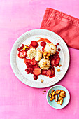 Vegan coconut rice pudding balls with berry sauce and nuts