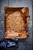 Leftover food on a baking tray lined with baking paper