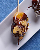 Chocolate fondue with tangerine and sweet crumbs