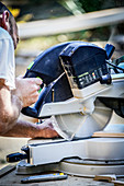 Worker using electric saw