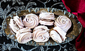 Black currant meringue cookies with whipped chocolate filling