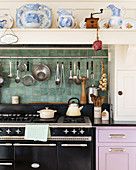 Crockery on mantel hood above gas cooker