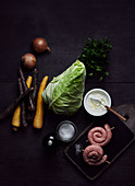 Ingredients for pointed cabbage stew with bratwurst snails