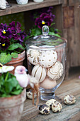 Easter eggs decorated with gold pen in glass sweet jar