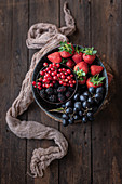 Various berries and grapes on wooden table
