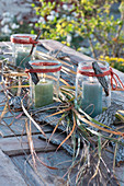 Lanterns with grass and bark as a table decoration