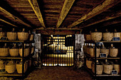 Eau-de-vis in glass flagons in a maturing cellar, Hennessy, Cognac, Charente, France