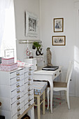Chest of drawers next to desk in shabby-chic style