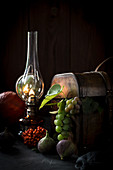 Autumn still life with fruits, a wooden box and a kerosene lamp