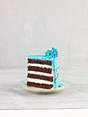 A slice of caramel cake with turquoise icing