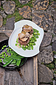 Venison medallions with oyster and veal sweetbread on a bed of peas