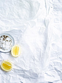 White paper background with salt and pepper and lemon