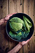 A fresh savoy cabbage in a bowl