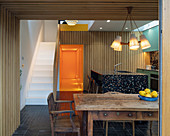 Old wooden table in open-plan kitchen of modern building