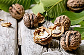 Organic walnuts, whole and broken, with green leaves