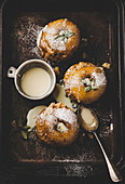 Baked apples with custard on baking sheet