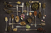 Assortment of dry tea in vintage spoons.